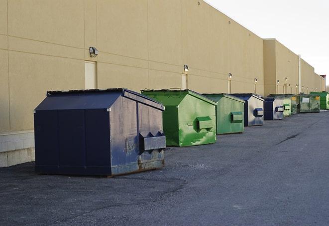 dumpsters with safety cones in a construction area in Asherton